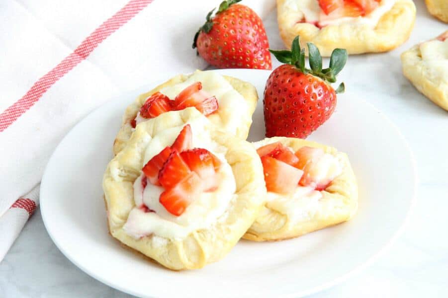 Making Strawberry Cream Cheese Danishes should probably be on your weekend agenda stat. They're so easy, and completely irresistible. Strawberry Cream Cheese Danish on white plate