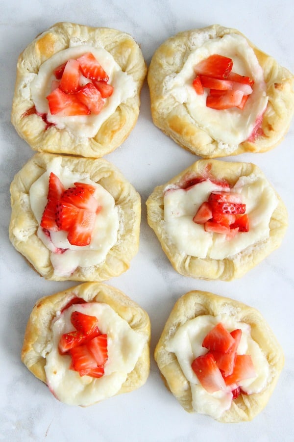 Making Strawberry Cream Cheese Danishes should probably be on your weekend agenda stat. They're so easy, and completely irresistible. Strawberry Cream Cheese Danish on white background