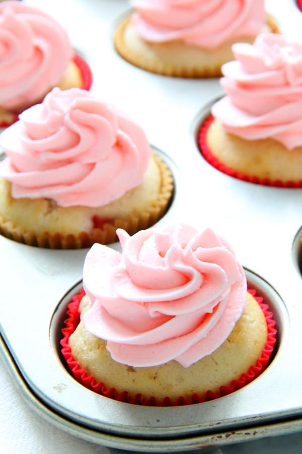 These Strawberry Lemon Cupcakes are a made from scratch cupcake! So moist with a little strawberry in each bite topped off with cream cheese frosting! | The Bitter Side of Sweet Strawberry Lemon Cupcakes in muffin pan
