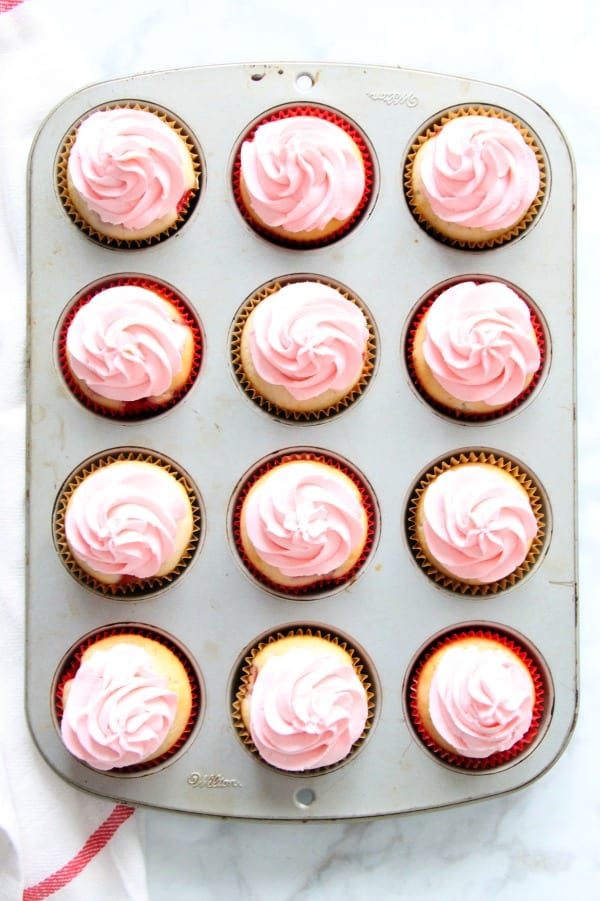 These Strawberry Lemon Cupcakes are a made from scratch cupcake! So moist with a little strawberry in each bite topped off with cream cheese frosting! | The Bitter Side of Sweet Strawberry Lemon Cupcakes in muffin pan