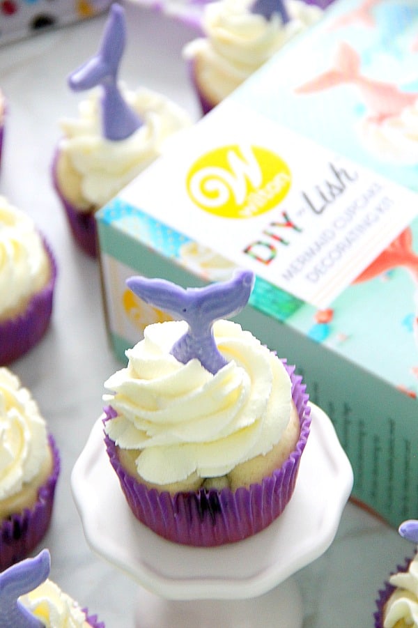 These Blueberry Lemonade Mermaid Cupcakes are so fun for a summer party! The kids would love the make the mermaid tails with you! | The Bitter Side of Sweet Blueberry Lemonade Mermaid Cupcakes in purple cupcake liner