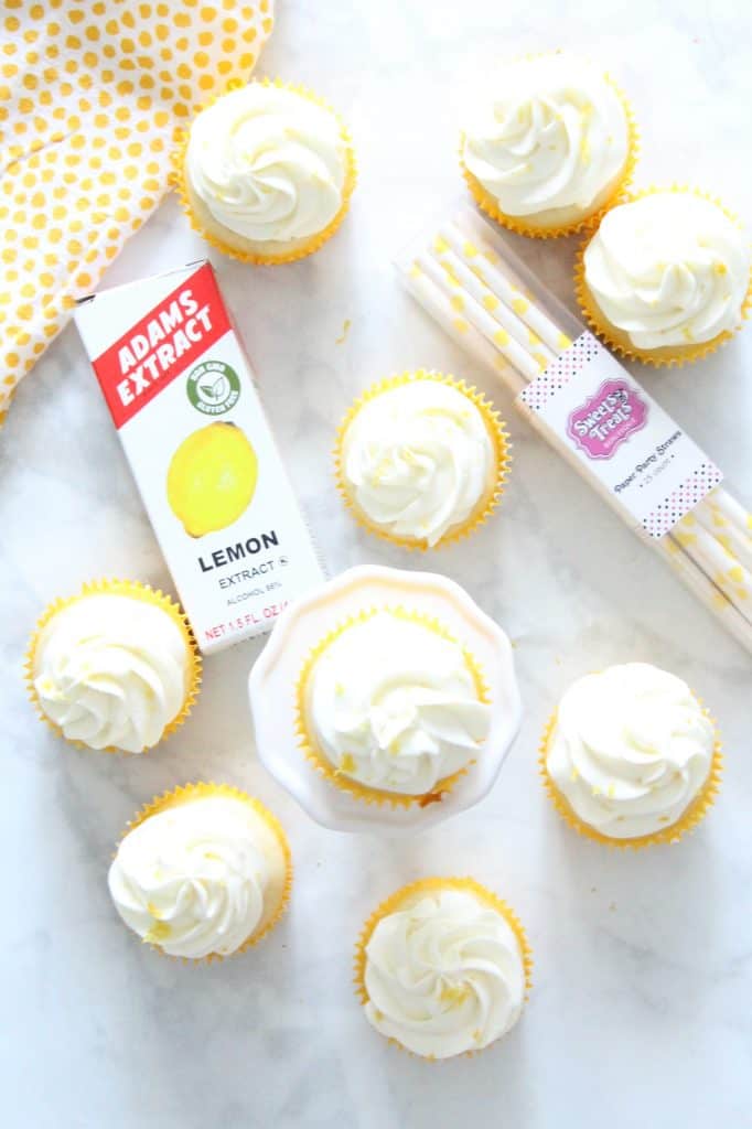 Moist and delicious Homemade Lemon Cupcakes topped with a homemade cream cheese frosting with added lemon zest. Perfect for any day of the week! | The Bitter Side of Sweet Lemon Cupcakes on white background