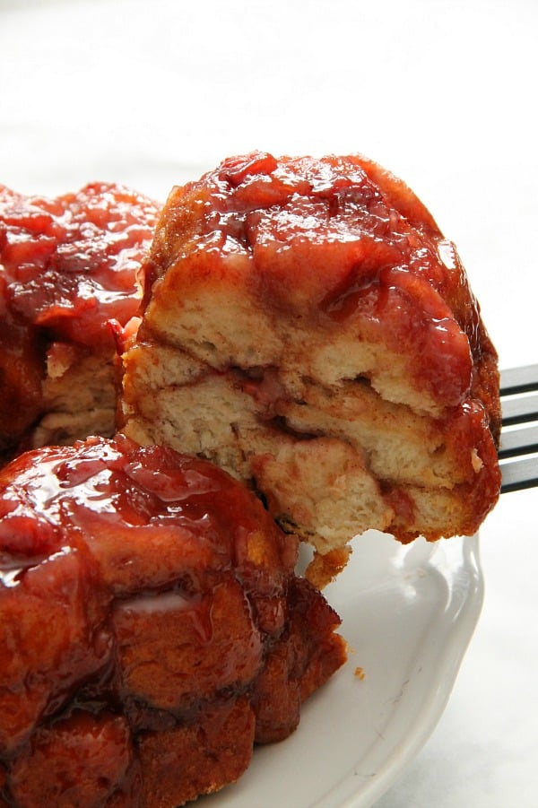 Soft, sticky Strawberry Monkey Bread is deliciously flavored with freshly cooked strawberries! Perfect for breakfast or a special treat! | The Bitter Side of Sweet Strawberry Monkey Bread on white plate