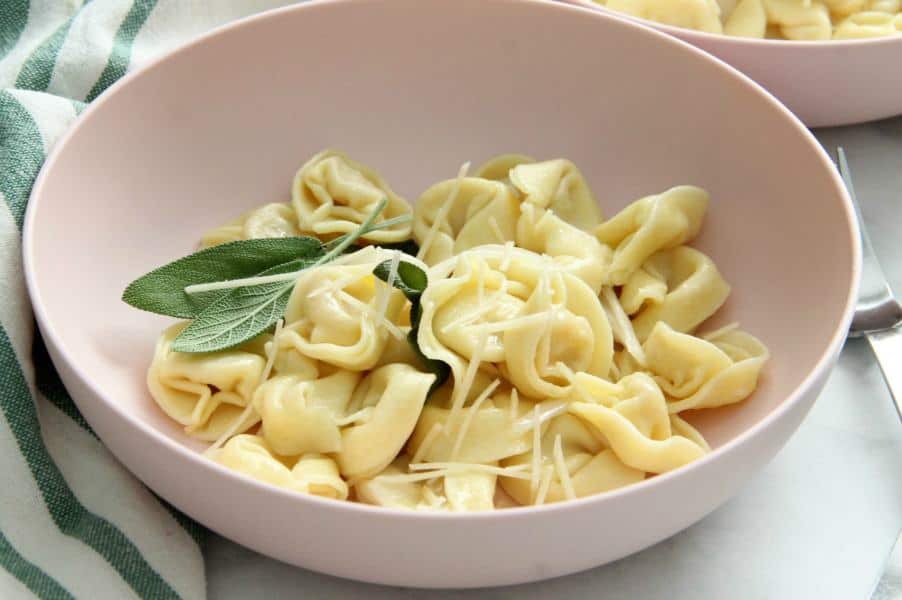 Tortellini with Butter and Sage is the easiest supper! Your family will love it! You can make it in minutes, but it's just so fancy. Tortellini with Butter and Sage in light pink bowl