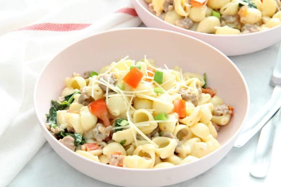 Creamy Sausage and Tomato Pasta couldn't be simpler with just a few ingredients. It's a fantastic Italian supper for any night of the week. Creamy Sausage and Tomato Pasta in bowl