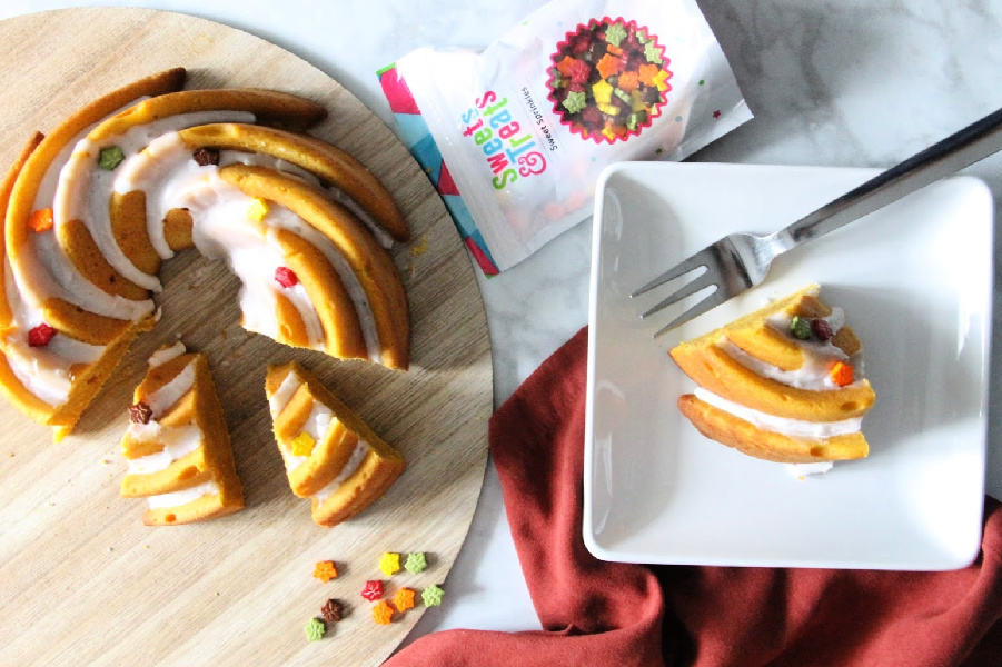 Moist and delicious Easy Pumpkin Bundt Cake is a must to make this fall season! Spiced with a little cinnamon and a lot of pumpkin this cake is simple! Easy Pumpkin Bundt Cake on brown background