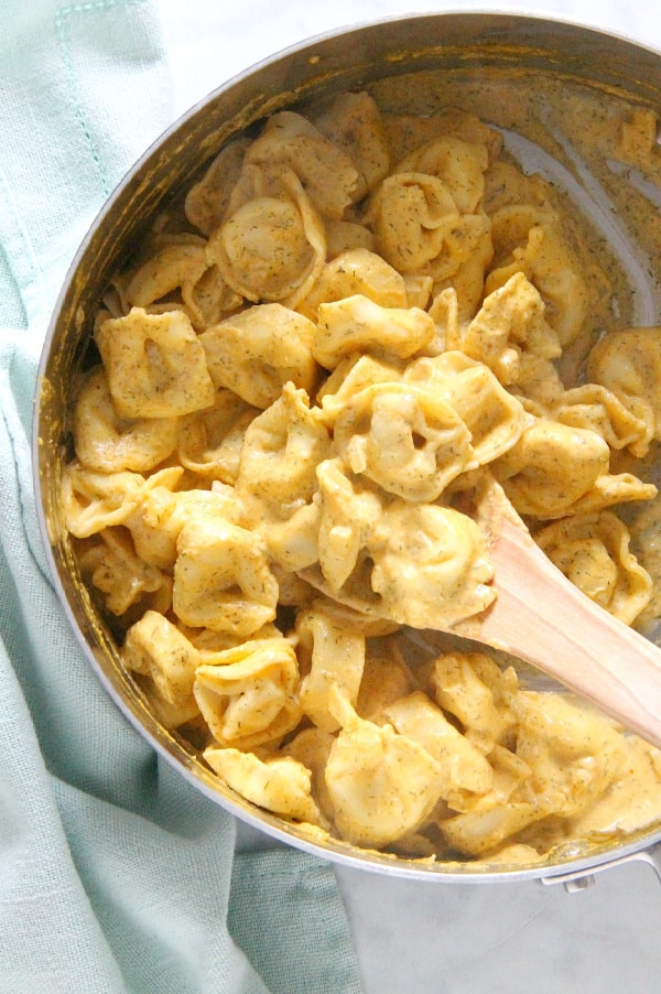 Creamy Pumpkin Tortellini is the simple supper your fall menu needs. This light, creamy sauce has just the right flavor profile to match up to pumpkin! Creamy Pumpkin Tortellini in pan