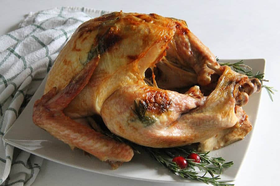 This Butter Rosemary Roasted Turkey will surely impress your guest! Cooked to perfection, this is moist buttery turkey with lots of flavor! | The Bitter Side of Sweet Butter Rosemary Roasted Turkey on white plate