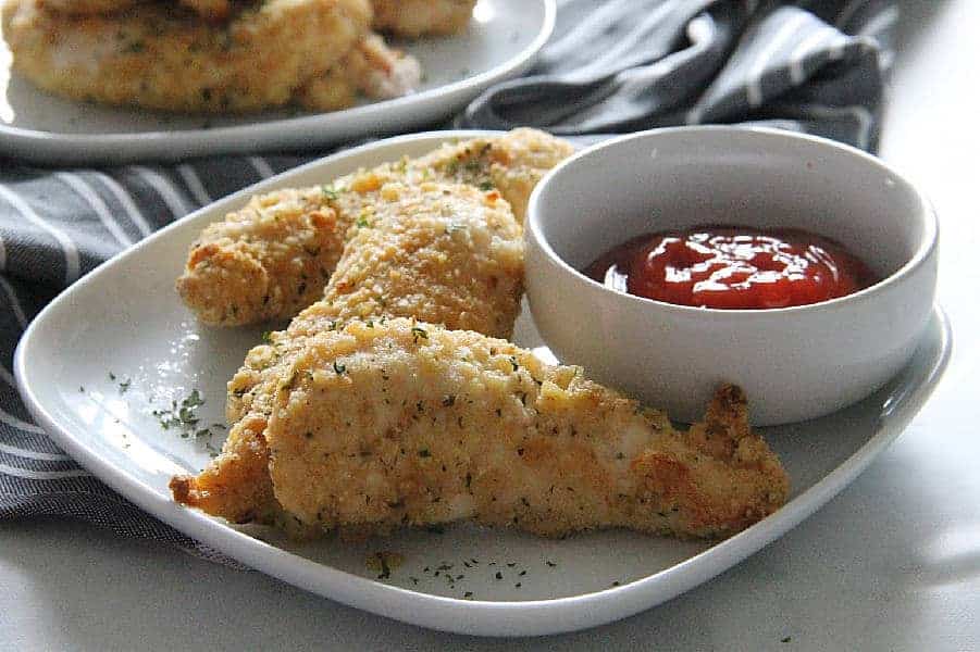 Easy Oven Baked Chicken Tenderloins is crispy and delicious! Bakes up in 20 minutes and makes for a quick weeknight dinner! | The Bitter Side of Sweet Easy Oven Baked Chicken Tenderloins on white plate