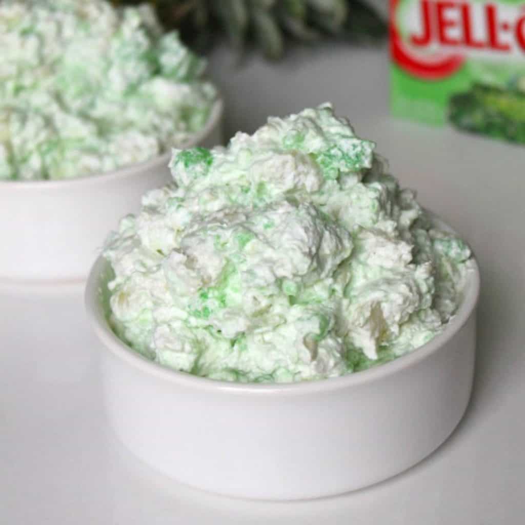 Sea Foam Salad is the perfect no bake dessert anytime of the year! We love for around the holidays! Just a few simple ingredients and it is ready to go! Sea Foam Salad in a white bowl
