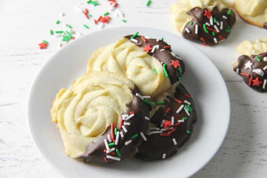 Italian Butter Cookies are just like what you would find in Italian bakeries! Dipped in chocolate and sprinkles, they're a spectacular treat. Italian Butter Cookies on white plate