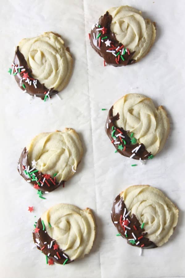 Italian Butter Cookies are just like what you would find in Italian bakeries! Dipped in chocolate and sprinkles, they're a spectacular treat. Italian Butter Cookies on white background