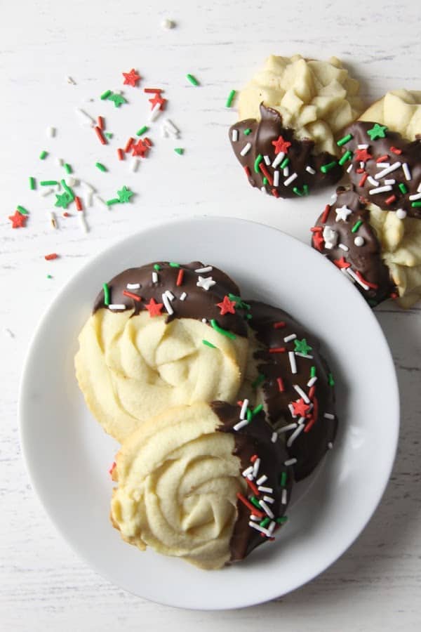 Italian Butter Cookies are just like what you would find in Italian bakeries! Dipped in chocolate and sprinkles, they're a spectacular treat. Italian Butter Cookies on white plate