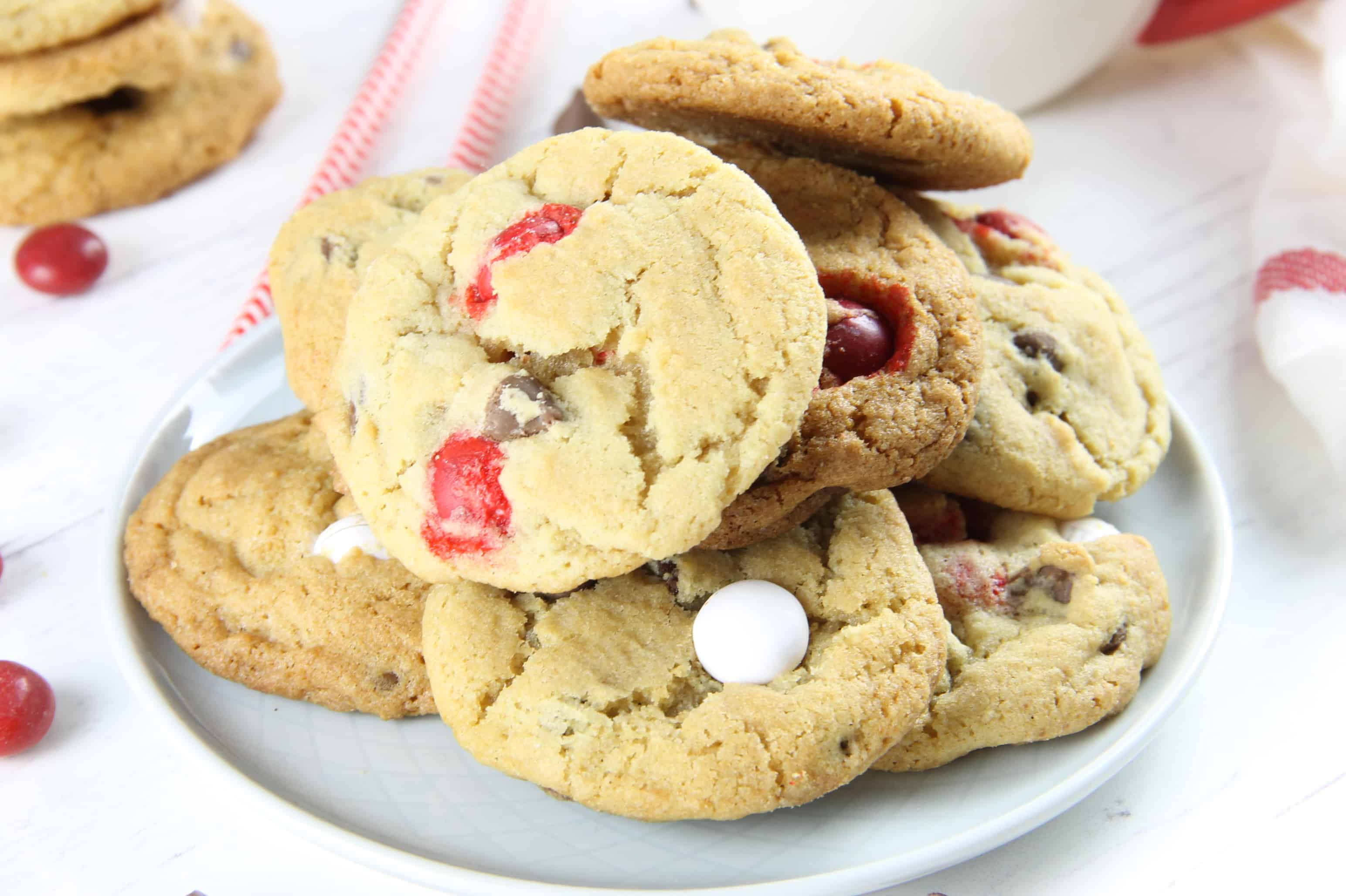 These Peppermint Chocolate Chip Cookies couldn't be any easier! With an abundant amount of chocolate goodness these chewy cookies will be a hit! Peppermint Chocolate Chip Cookies on a white plate