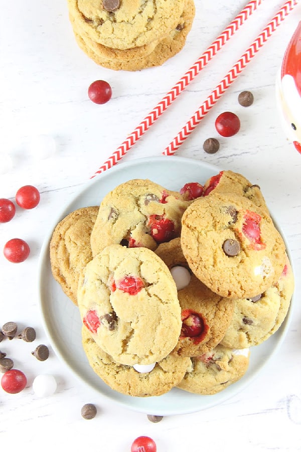 These Peppermint Chocolate Chip Cookies couldn't be any easier! With an abundant amount of chocolate goodness these chewy cookies will be a hit! Peppermint Chocolate Chip Cookies on a white plate