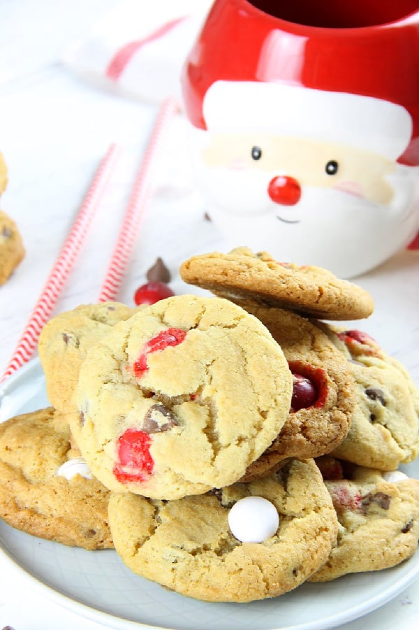 These Peppermint Chocolate Chip Cookies couldn't be any easier! With an abundant amount of chocolate goodness these chewy cookies will be a hit! Peppermint Chocolate Chip Cookies on white plate