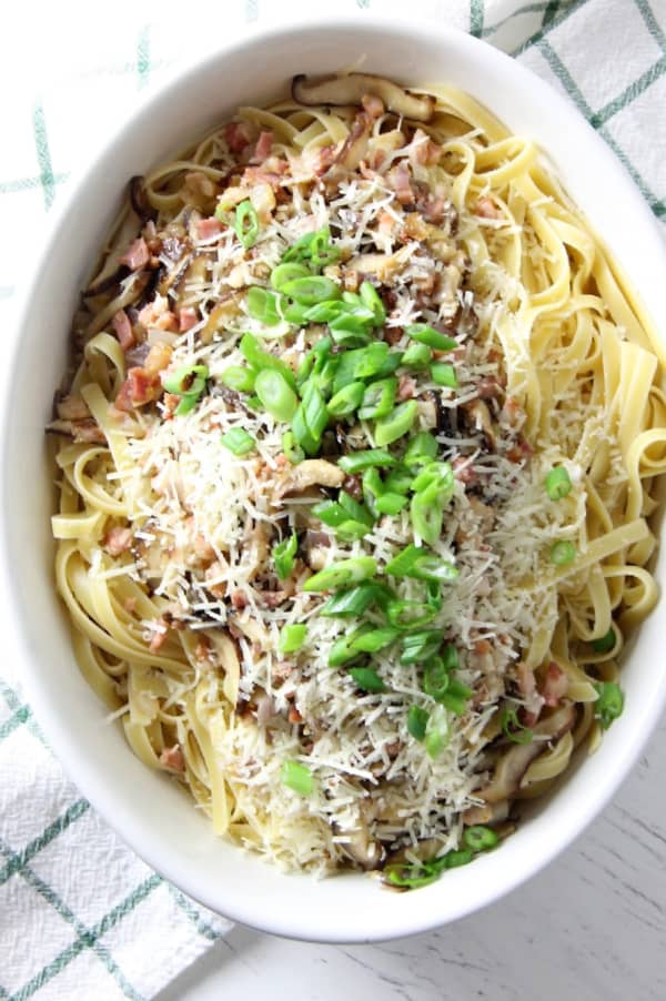This Pancetta Mushroom Fettuccine can make an easy weeknight dinner, or a date night dinner. It comes together quickly, but feels fancy! | The Bitter Side of Sweet Pancetta and Mushroom Fettuccine in white bowl
