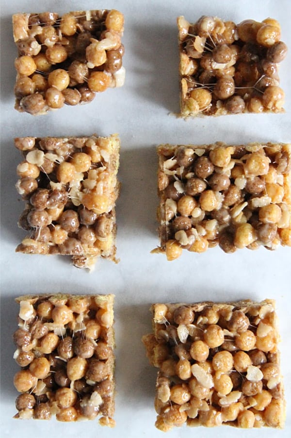 Chocolate Peanut Butter Marshmallow Treats are an ooey, gooey treat! With two different types of cereal and lots of marshmallows, these will not disappoint! Chocolate Peanut Butter Marshmallow Treats on background