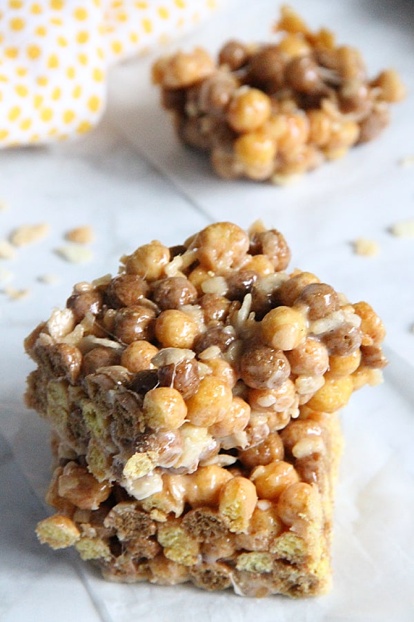 Chocolate Peanut Butter Marshmallow Treats are an ooey, gooey treat! With two different types of cereal and lots of marshmallows, these will not disappoint! Chocolate Peanut Butter Marshmallow Treats on white background