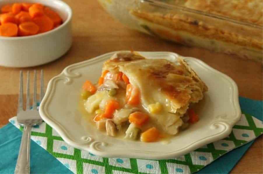 Easy Homemade Chicken Pot Pie made with simple pantry staples and a homemade buttery crust for the top of this delicious pie! Homemade Chicken Pot Pie on white plate