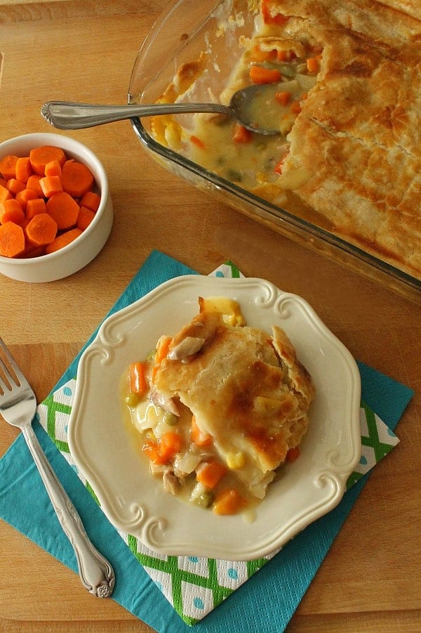 Easy Homemade Chicken Pot Pie made with simple pantry staples and a homemade buttery crust for the top of this delicious pie! Homemade Chicken Pot Pie on white plate