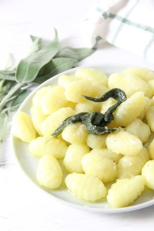 This Sage Butter Gnocchi is one delectable dinner. The sauce is made with a few simple ingredients! Cooks up in about 5 minutes! Sage Butter Gnocchi on white plate