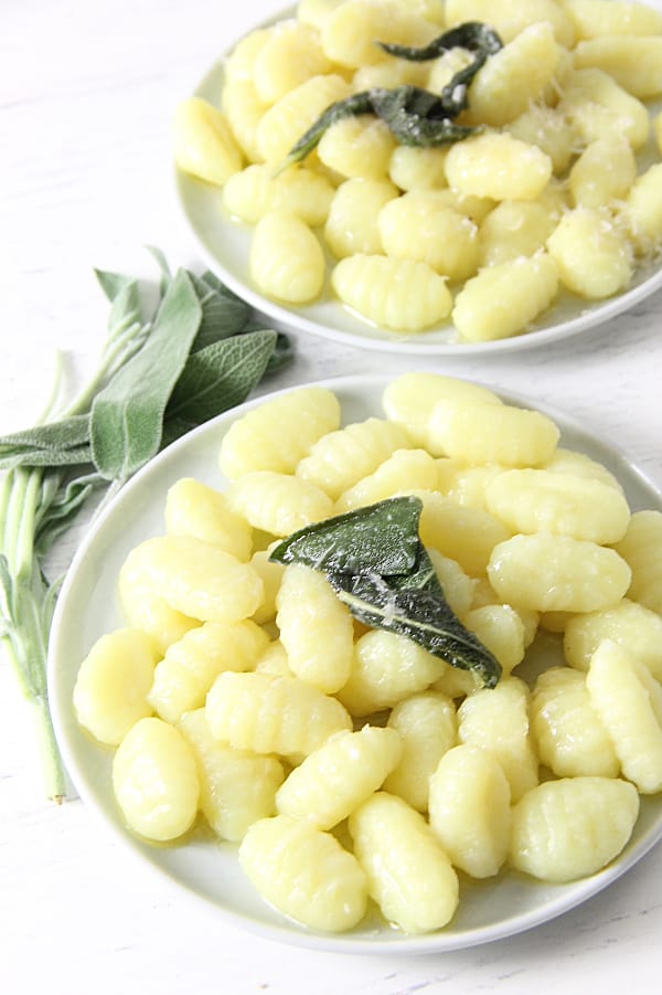 This Sage Butter Gnocchi is one delectable dinner. The sauce is made with a few simple ingredients! Cooks up in about 5 minutes! Sage Butter Gnocchi on white plate
