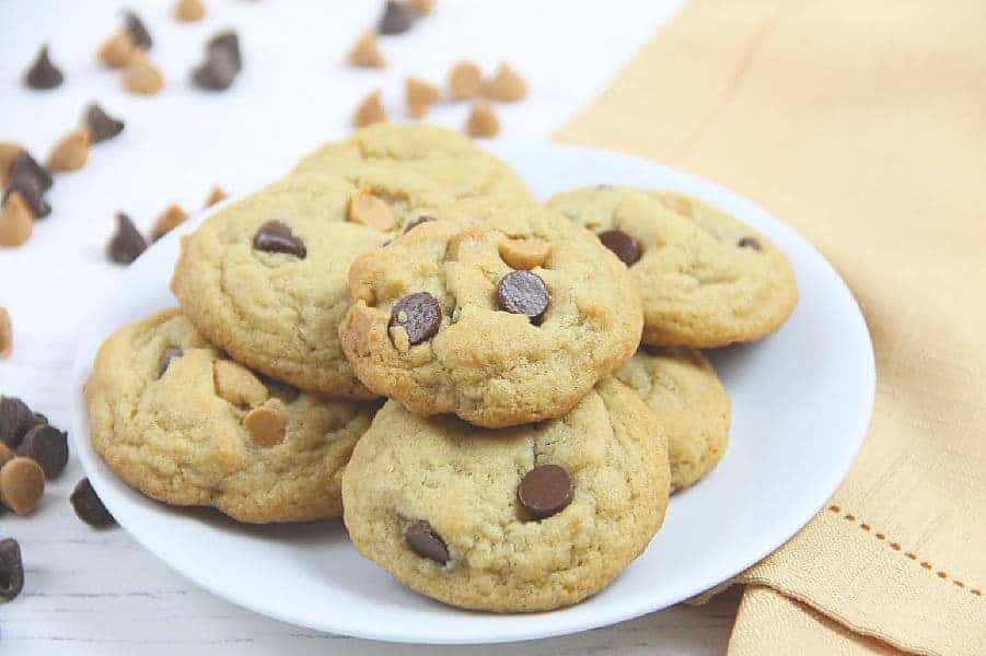 Soft and chewy Peanut Butter Chocolate Chip Cookies! Made with peanut butter chips these cookies bake up in less than 10 minutes! Peanut Butter Chocolate Chip Cookies on white plate