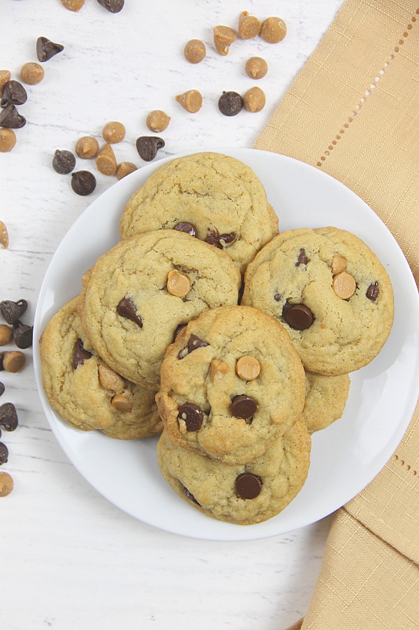 Soft and chewy Peanut Butter Chocolate Chip Cookies! Made with peanut butter chips these cookies bake up in less than 10 minutes! Peanut Butter Chocolate Chip Cookies on white plate