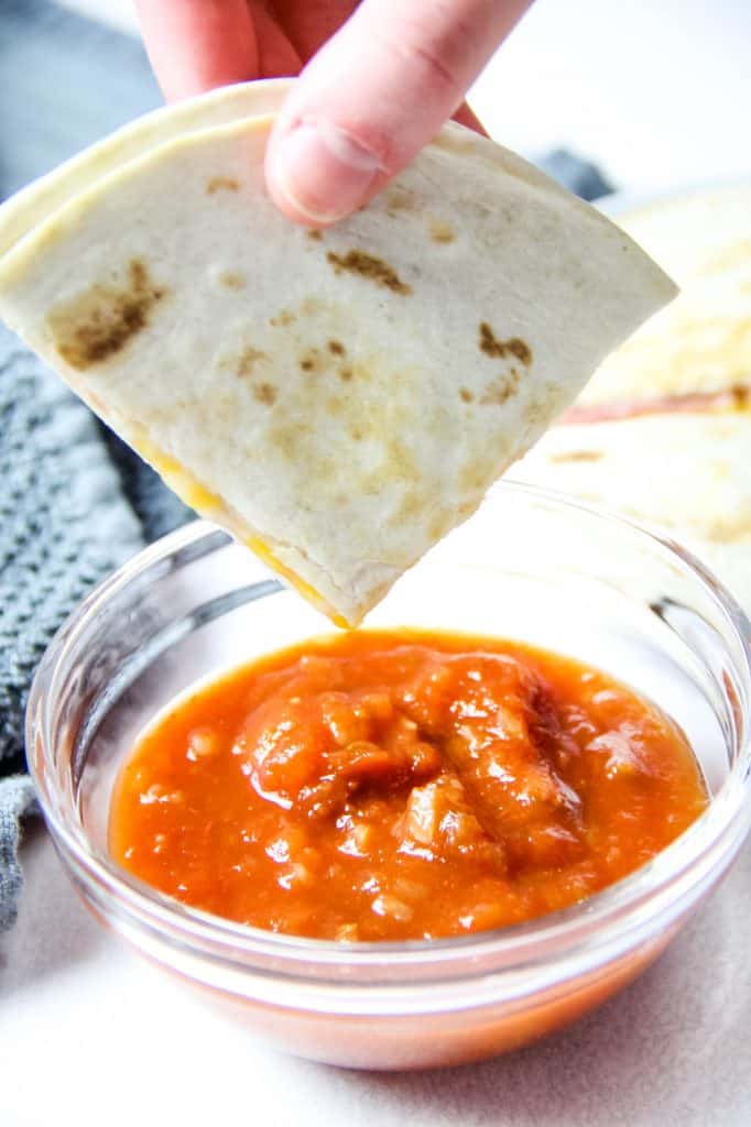 Easy Ham and Cheese Quesadillas made with 3 ingredients and perfect for a quick lunch or snack! Flour tortillas topped with deli ham and Mexican cheese! Ham and Cheese Quesadillas dipped in salsa