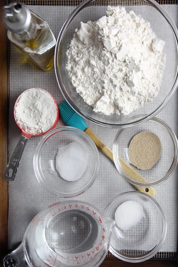 This Homemade Italian Bread is super easy to make with only 6 ingredients and very little time kneading it! Baked up in the oven for a perfect crispy bread! Homemade Italian Bread ingredients on sheet pan