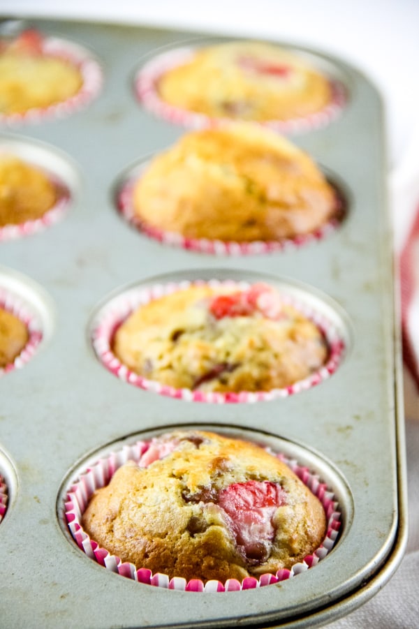 Strawberry Oatmeal Muffins are a hearty, soft breakfast muffin! Studded with fresh strawberries, these portable muffins will become a delicious favorite! Strawberry Oatmeal Muffins in pink cupcake liner in muffin pan