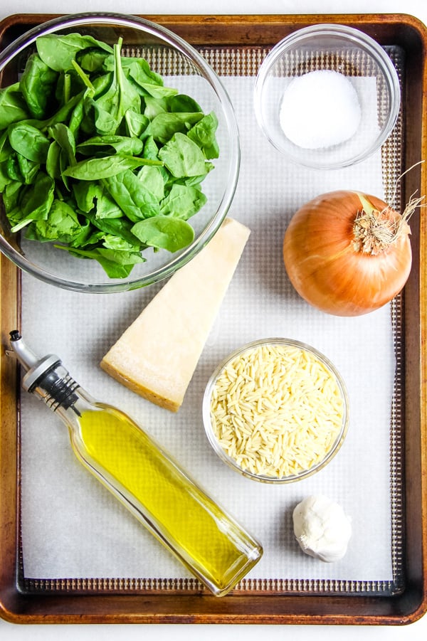 This Cheesy Spinach Orzo is an easy 20 minute meal! Made with fresh spinach, onions and garlic this tasty pasta is also loaded with freshly grated cheese!