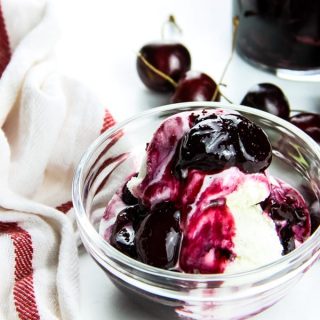 Easy Cherry Compote on ice cream in glass bowl