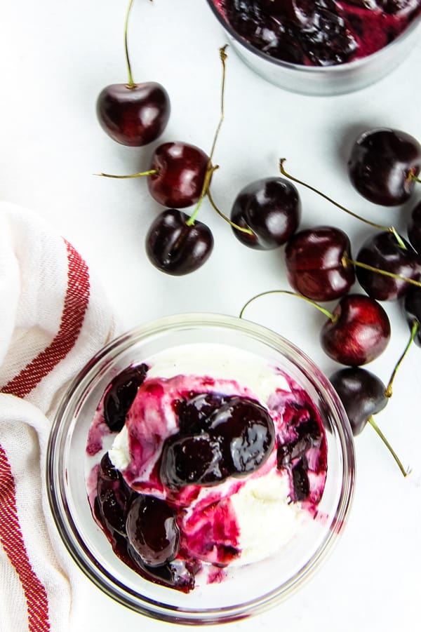 With 4 ingredients this Easy Cherry Compote is the best topping for putting on ice cream, pound cake, or even granola! Perfectly made with fresh cherries! Easy Cherry Compote overhead view in glass bowl over ice cream