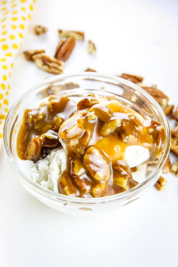 Easy Butter Pecan Sauce made with 6 ingredients! A creamy, gooey sauce filled with pecans and perfect topping for ice cream or any dessert! Butter Pecan Sauce in glass bowl with ice cream