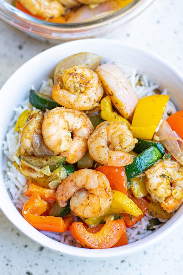 Easy Garlic Thyme Shrimp and Veggies! Cooks up in 10 minutes! This dish is loaded with lots of flavors and comes together in no time! Garlic Thyme Shrimp and Veggies in white bowl with rice