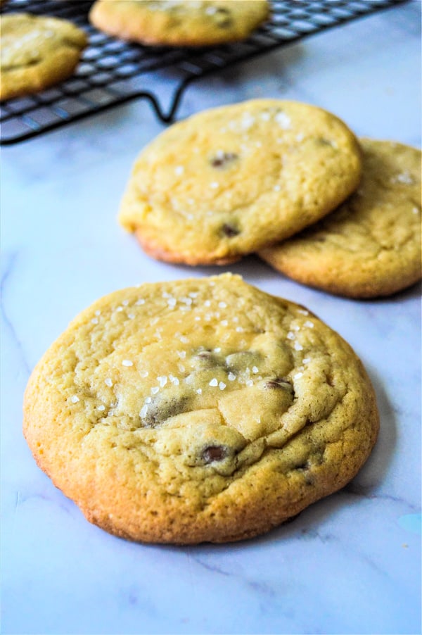 ea Salt Brown Sugar Chocolate Chip Cookies are made with a hint of salt, brown sugar combined with chocolate chips for the perfect cookie! Sea Salt Brown Sugar Chocolate Chip Cookies on grey background