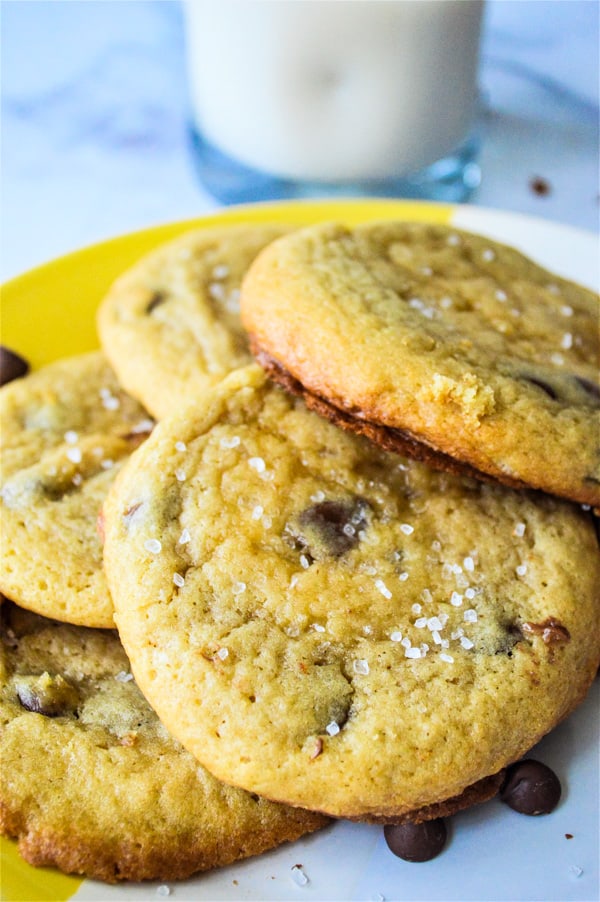 ea Salt Brown Sugar Chocolate Chip Cookies are made with a hint of salt, brown sugar combined with chocolate chips for the perfect cookie! Sea Salt Brown Sugar Chocolate Chip Cookies stacked on yellow plate