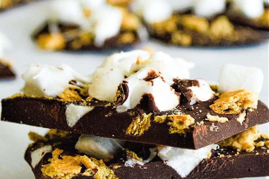 This Easy S'mores Bark has just 3 ingredients and is made in the microwave! Super fun for getting kids in the kitchen with you! S'mores Bark close up stacked on top of each other.