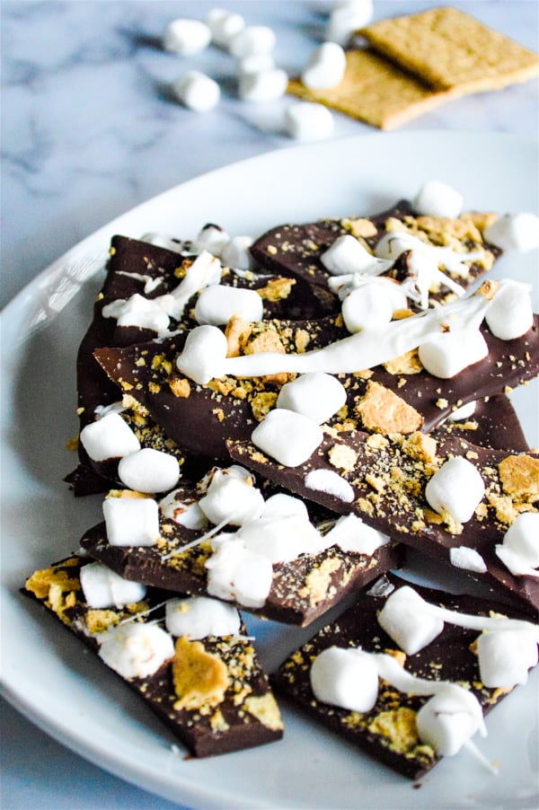 This Easy S'mores Bark has just 3 ingredients and is made in the microwave! Super fun for getting kids in the kitchen with you! S'mores Bark stacked on white plate