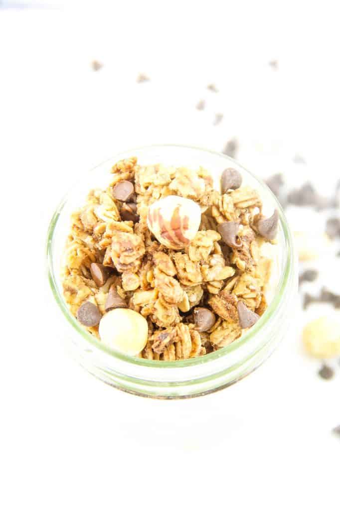 This Chocolate Hazelnut Granola is perfect for snacking! Made with nutella, oats, maple syrup and canola oil! Simple and easy! Chocolate Hazelnut Granola in glass jar topped with hazelnuts and chocolate chips