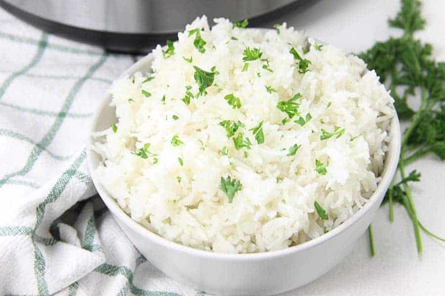 The EASIEST side dish to make! This Instant Pot Basmati Rice will be one that you make over and over again! Instant Pot Basmati Rice in white bowl