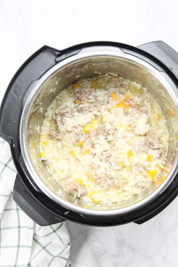 This Instant Pot Sausage and Peppers Risotto is perfect for a quick meal! Filled with Italian sausage and colorful peppers! Instant Pot Sausage and Peppers Risotto in pot