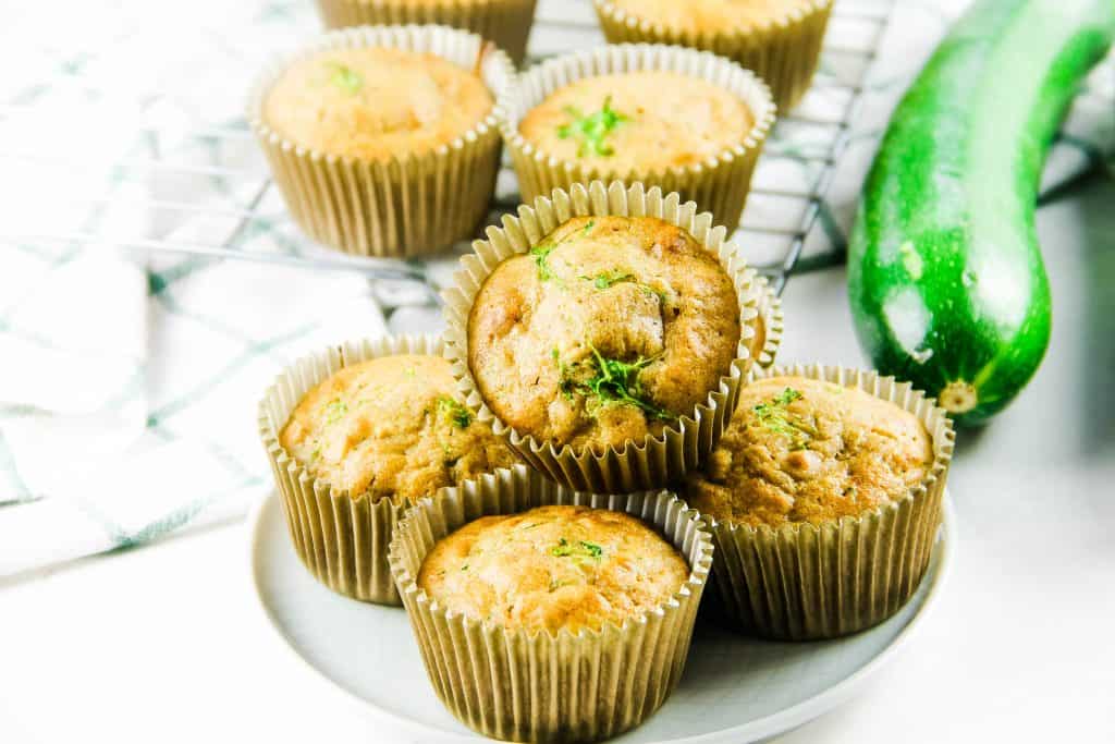 Easy Zucchini Oatmeal Muffins packed with shredded zucchini! Moist and flavorful with oats and zucchini. Perfect for hearty breakfast! Zucchini Oatmeal Muffins on plate