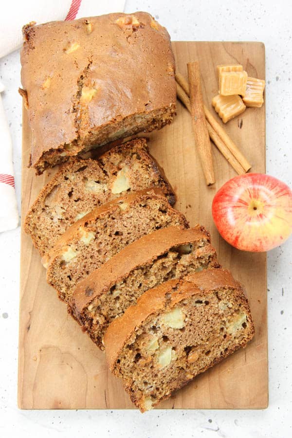 using all whole wheat flour, dried cranberries and pumpkin seeds. Caramel Apple Bread on cutting board