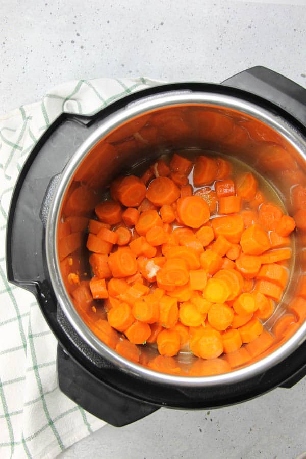 These Instant Pot Carrots are the easiest side dish! With just 5 ingredients and 6 minutes cook time, these come together quickly! Instant Pot Carrots cooked in pot with butter