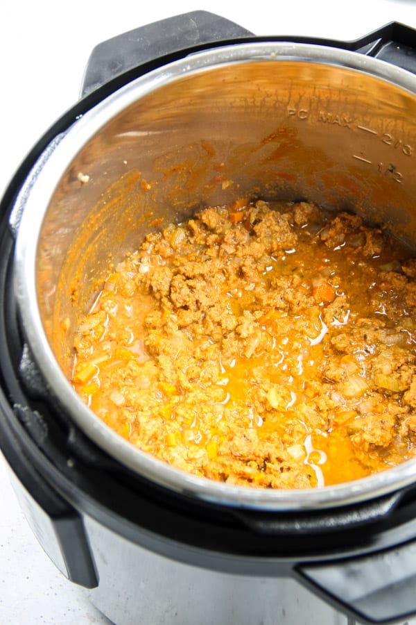 Easy Instant Pot Turkey Ragù! Made with ground turkey, herbs and tomato sauce this pasta sauce comes together quickly with the instant pot! Instant Pot Turkey Ragu cooked in pot