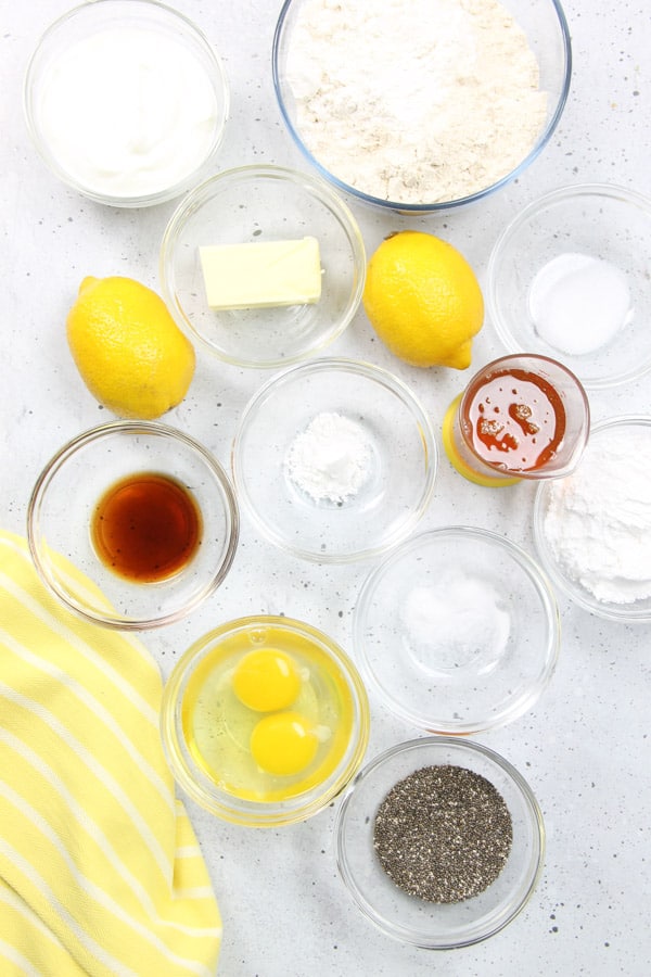 Easy Lemon Chia Muffins! Full of tangy, lemony flavor loaded with chia seeds for the perfect way to start the day! Packed with protein! Lemon Chia Muffins Ingredients in glass bowls