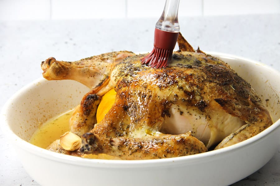This Oven Baked Whole Chicken is cooked up perfectly with lemon, garlic and herbs. Tender, moist and lemony chicken for dinner!